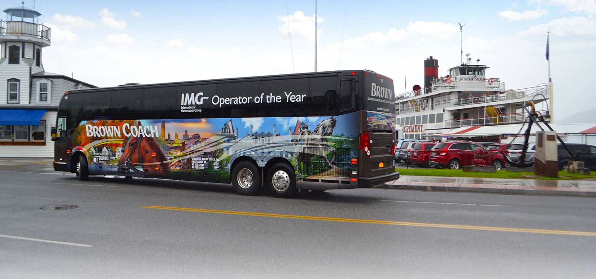 Brown Coach bus parked in front of a ship