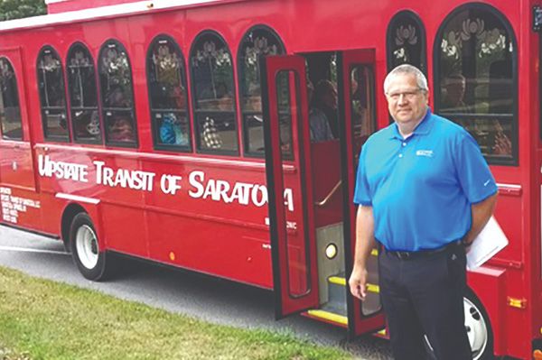 driver standing outside of trolley